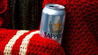 The best beer for the holidays | Sapporo wrapped in a red scarf