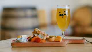 Alcohol delivery in Toronto | A charcuterie board and a pint of beer at Bandit Brewery and restaurant in Toronto